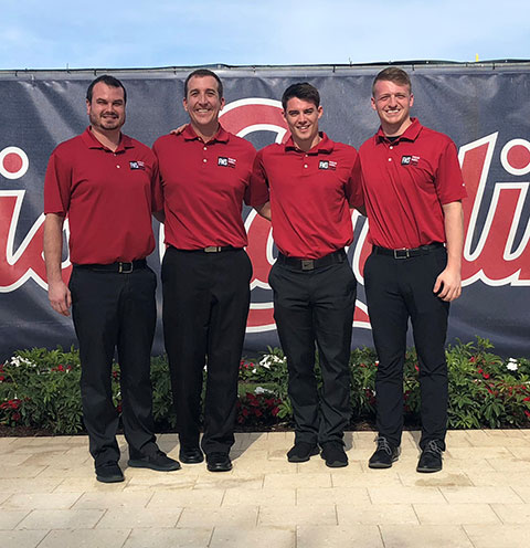 Four men in red shirts