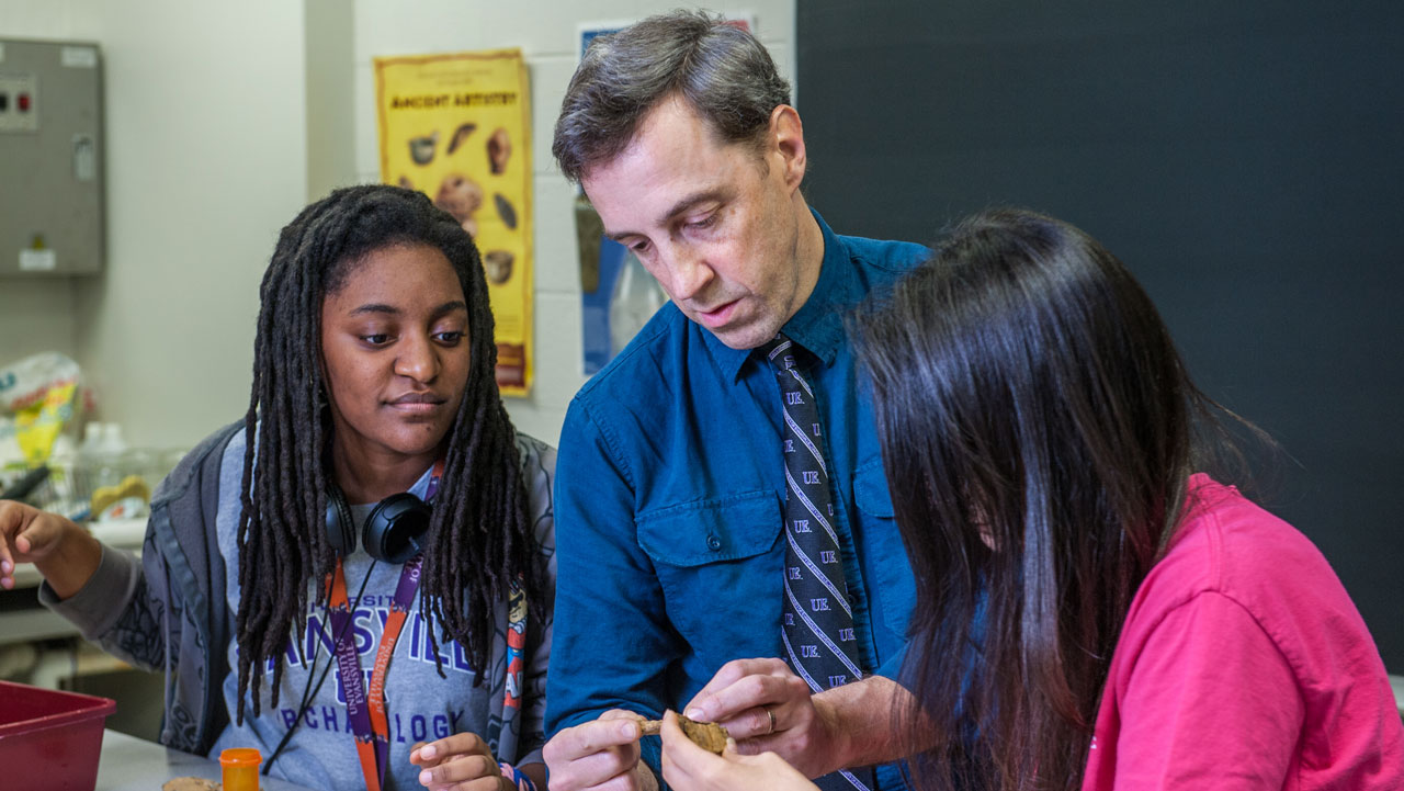 UE faculty Alan Kaiser in instructing two archaeology students