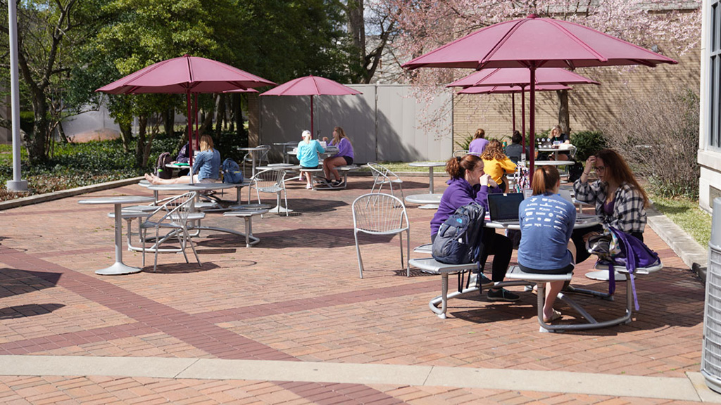 Three students walking in front of Ridgway University Center