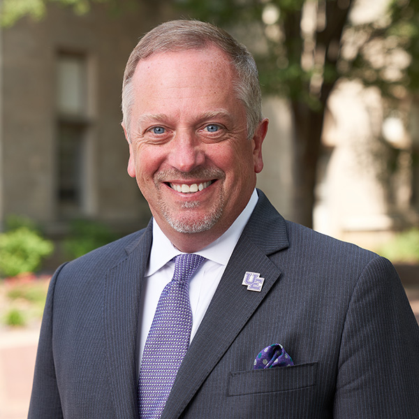 Christopher M. Pietruszkiewicz, Esq. outside on campus