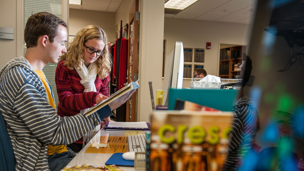 Two UE publication students working together on an upcoming edition of the Crescent Magazine