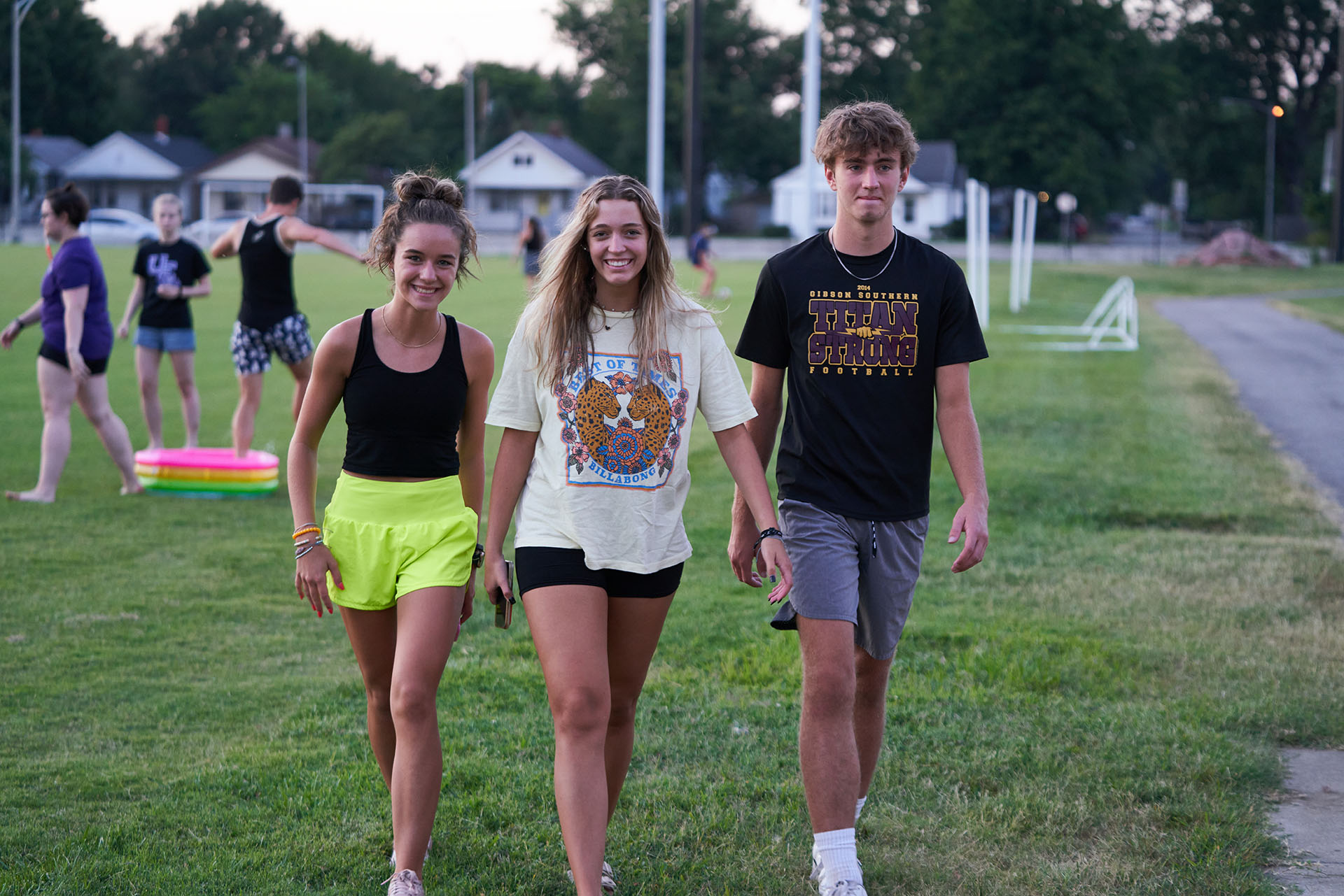 Welcome Week students walking across field.