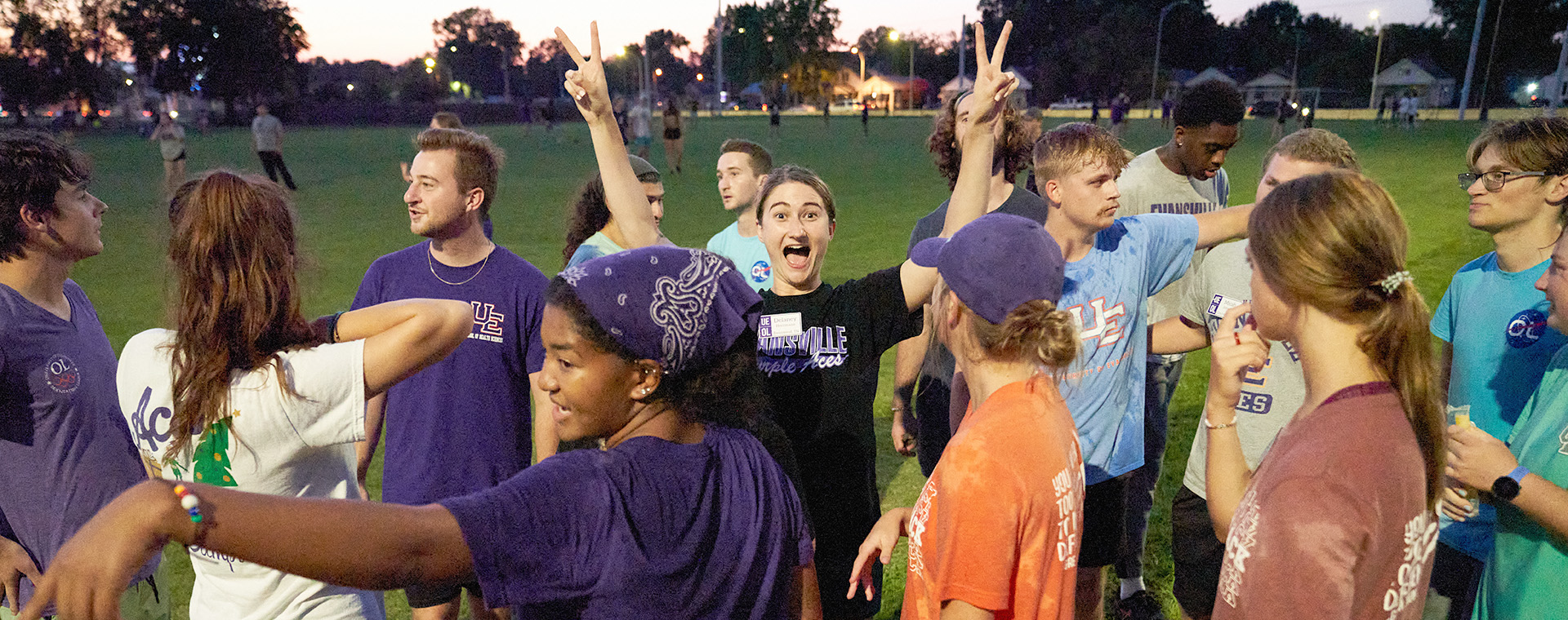 Student giving peace signs at Welcome Week gathering