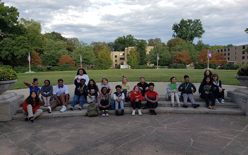 Camp students sitting on steps