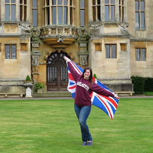 Kelly holding the British flag in front of Harlaxton