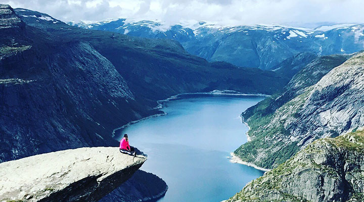 Sitting on a precipice overlooking a lake