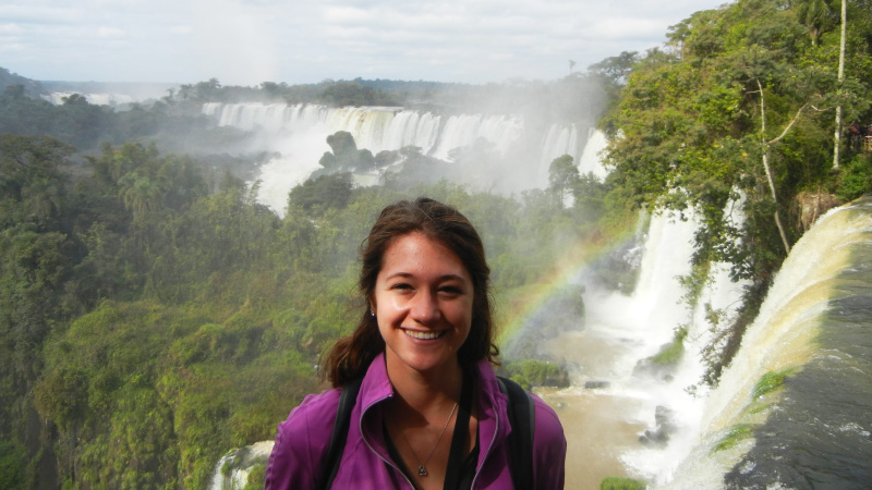 Amanda standing in front of Iguazu Falls