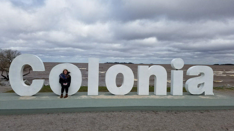 Elizabeth standing in the 'O' of the Colonia city sign.