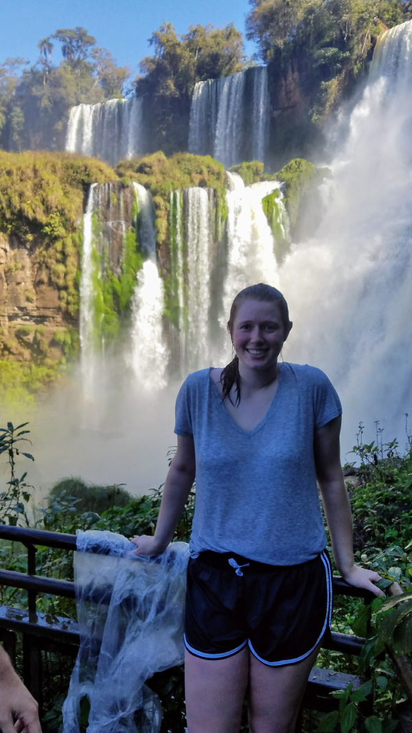 Elizabeth next to a waterfall.