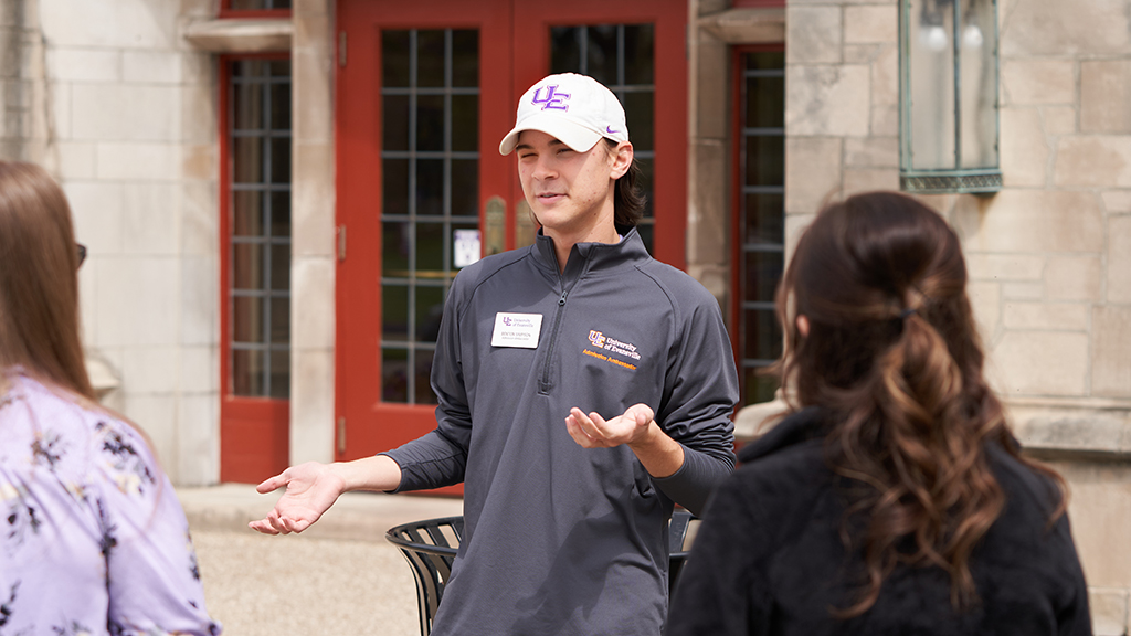 Student leading a tour outside