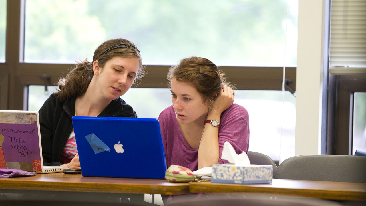 Two students using laptops